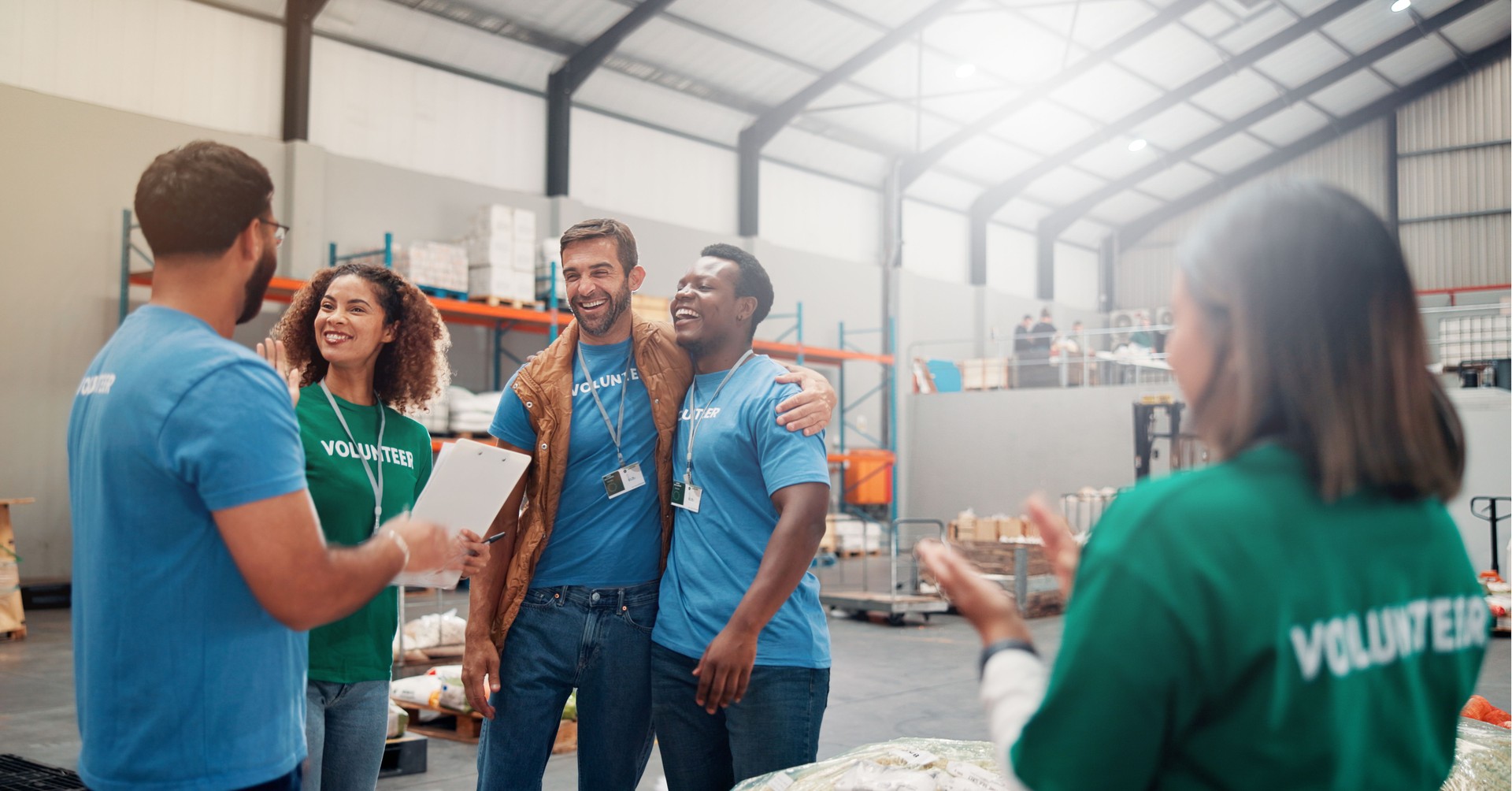 Volunteer group, people and celebration with applause in warehouse for outreach success, charity or donation target. NGO, social responsibility or teamwork with food bank project or community service